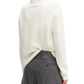 Person wearing a cream sweater and gray pinstripe pants on a white background