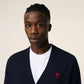 Navy blue cardigan with a red logo on a white background