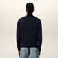 Navy blue cardigan with a red logo on a white background