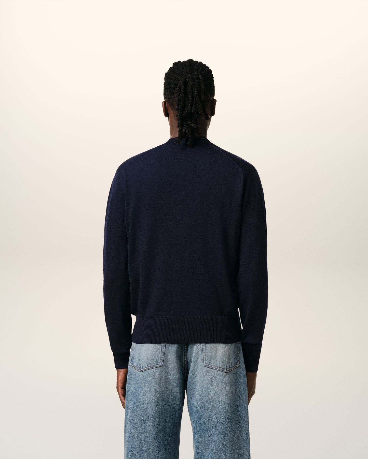 Navy blue cardigan with a red logo on a white background