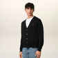 Black cardigan with a small red heart emblem on a white background