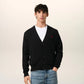 Black cardigan with a small red heart emblem on a white background