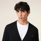 Black cardigan with a small red heart emblem on a white background