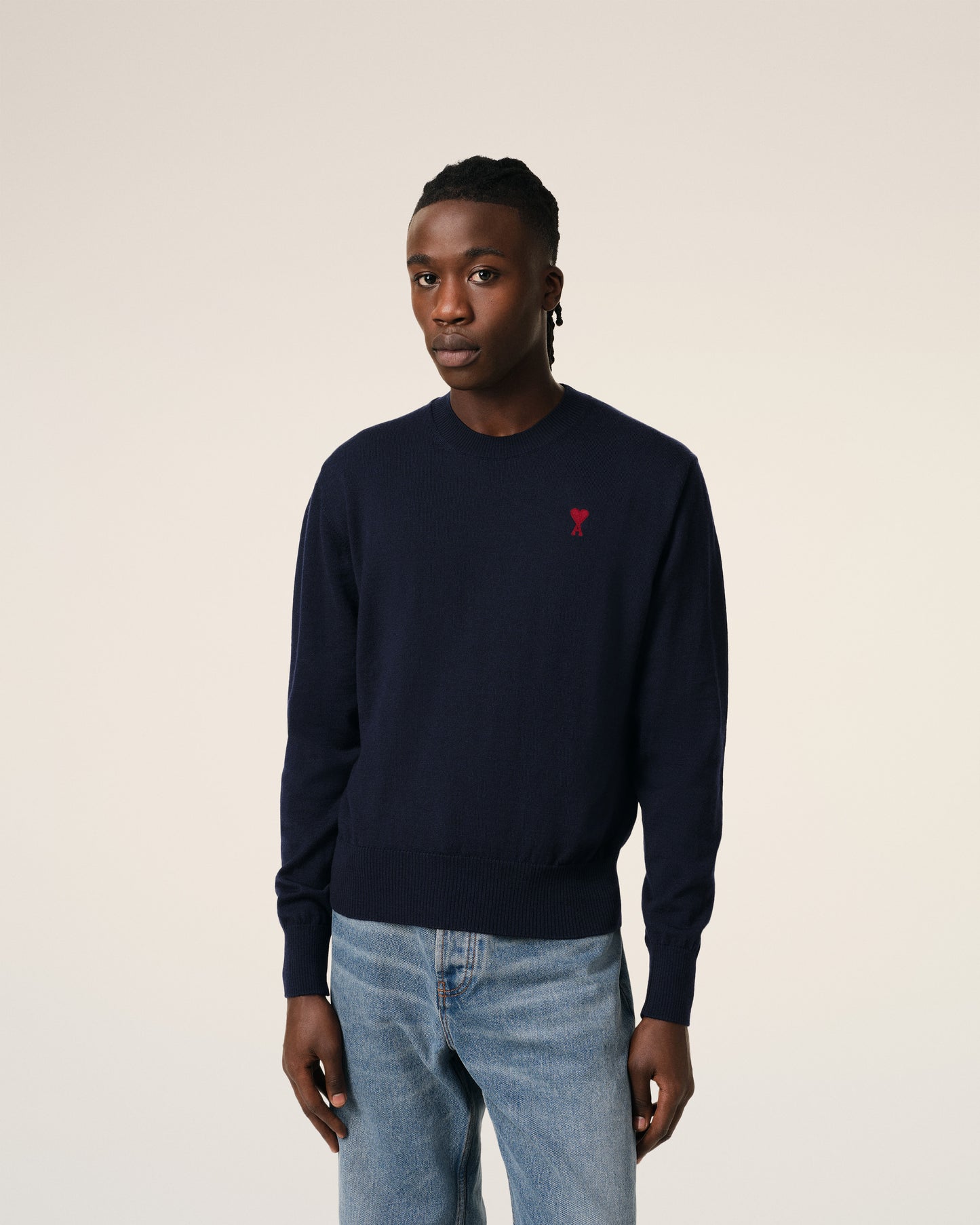 Navy blue sweater with a red heart and letter 'A' logo on a white background