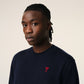 Navy blue sweater with a red heart and letter 'A' logo on a white background