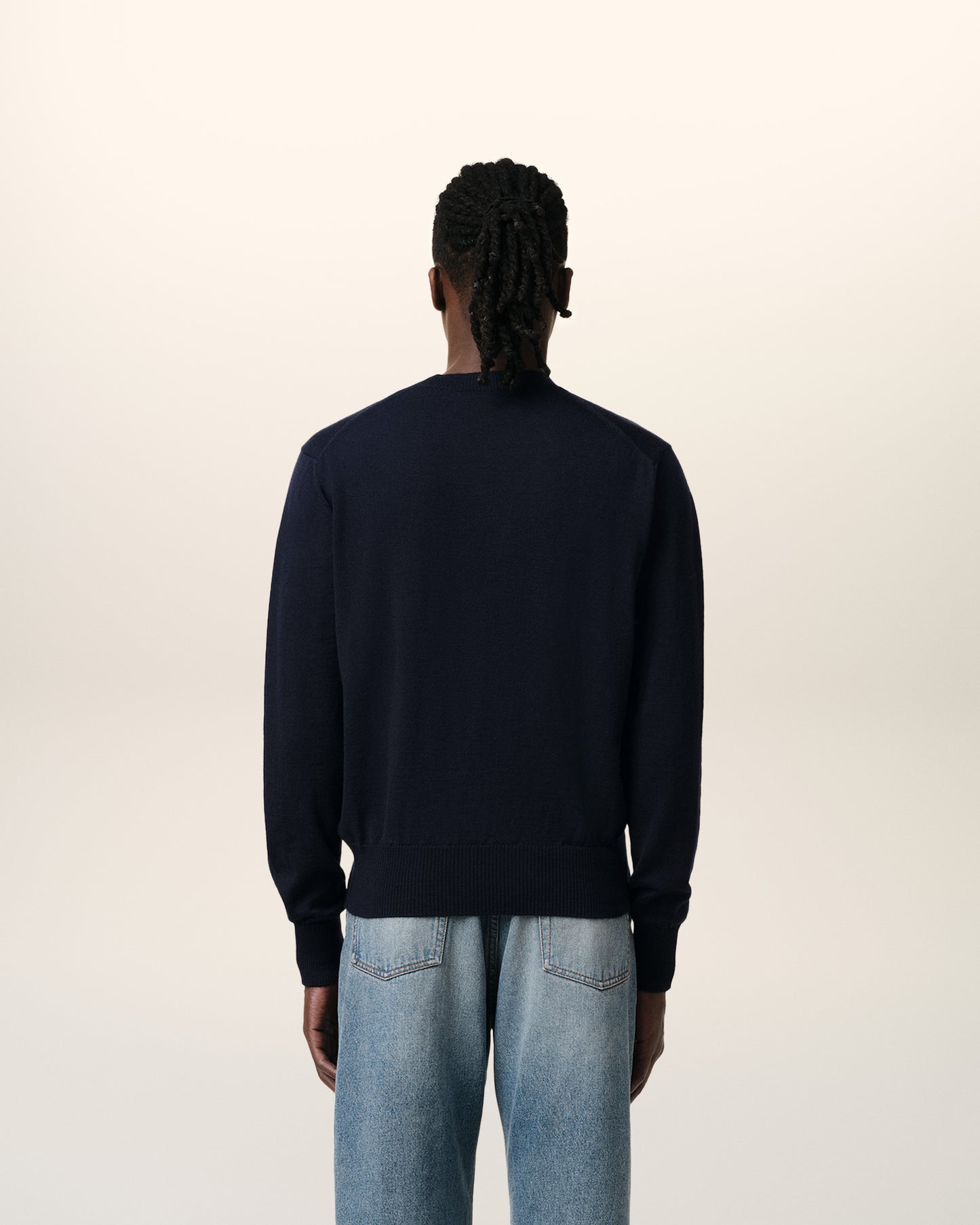Navy blue sweater with a red heart and letter 'A' logo on a white background
