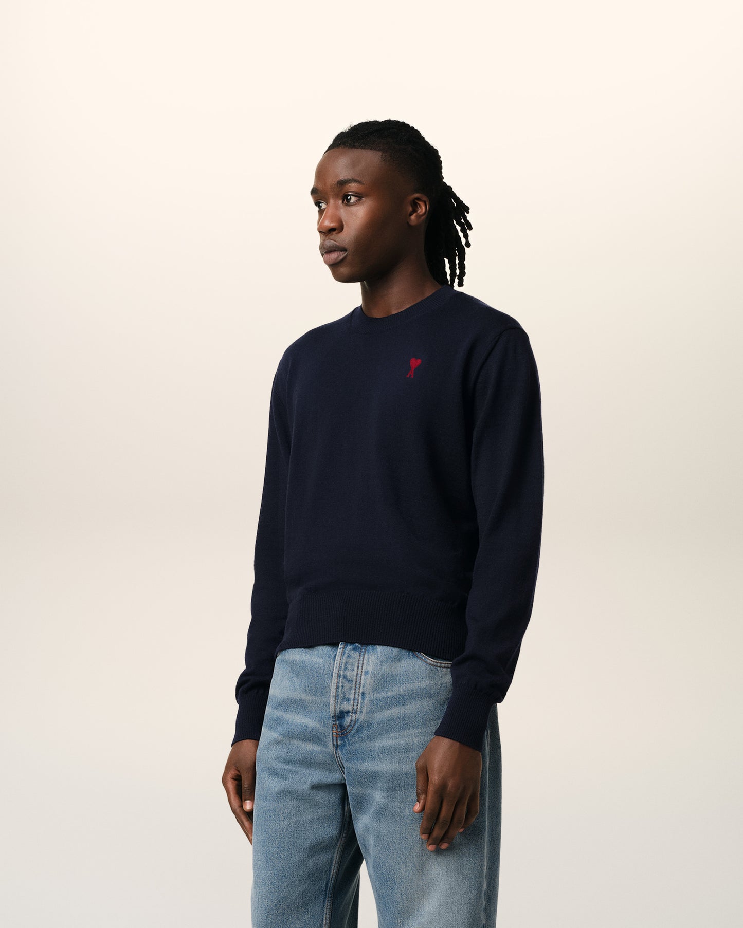 Navy blue sweater with a red heart and letter 'A' logo on a white background