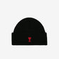 A black ribbed knit beanie hat featuring a small red embroidered heart logo with a letter A on the front cuff, set against a plain off-white background.