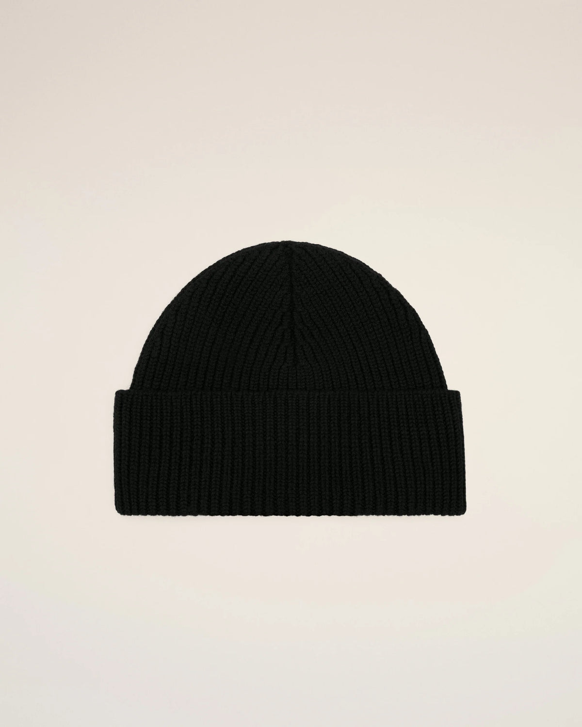 A black ribbed knit beanie hat featuring a small red embroidered heart logo with a letter A on the front cuff, set against a plain off-white background.