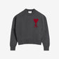Gray sweater with a red heart design on a beige background