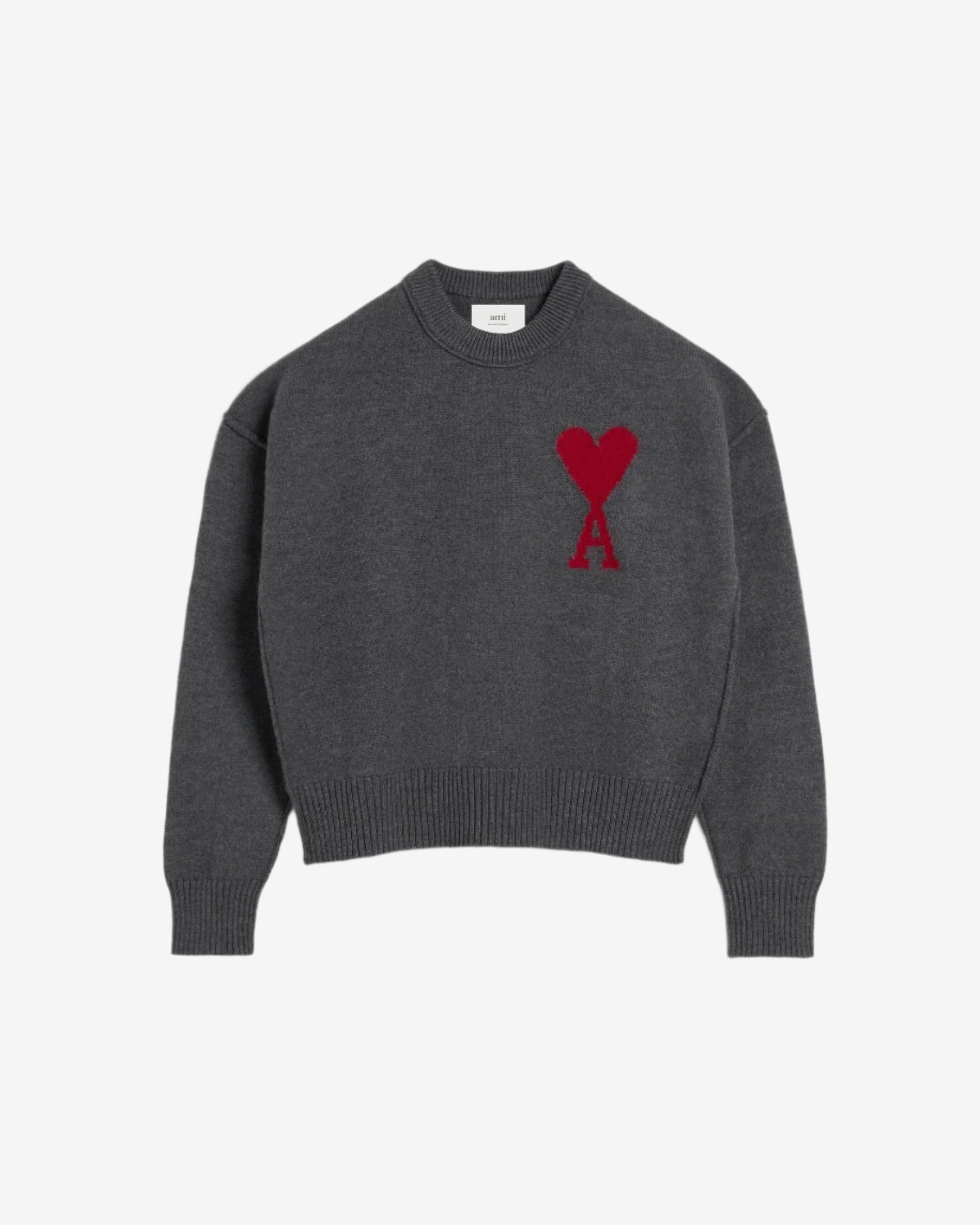 Gray sweater with a red heart design on a beige background