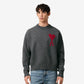 Gray sweater with a red heart design on a beige background