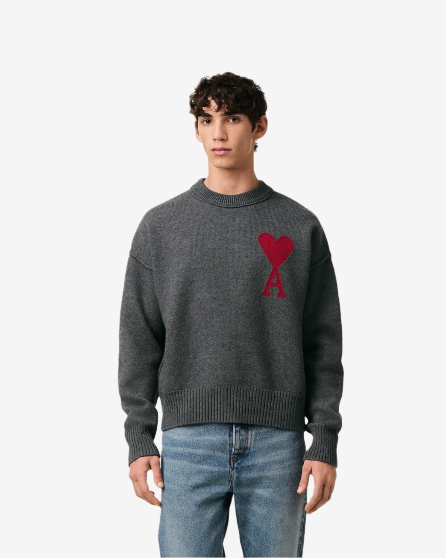 Gray sweater with a red heart design on a beige background