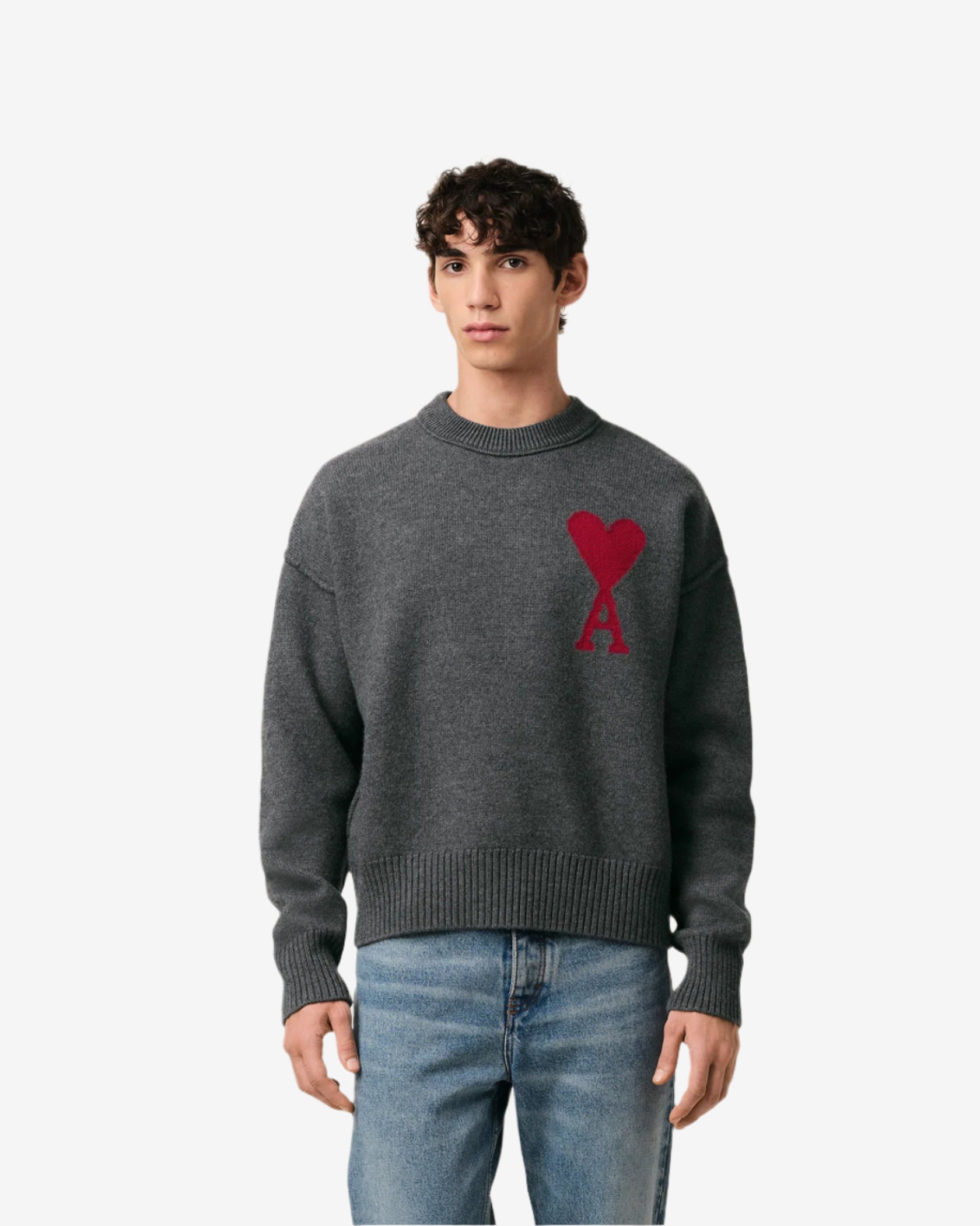 Gray sweater with a red heart design on a beige background
