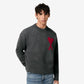 Gray sweater with a red heart design on a beige background