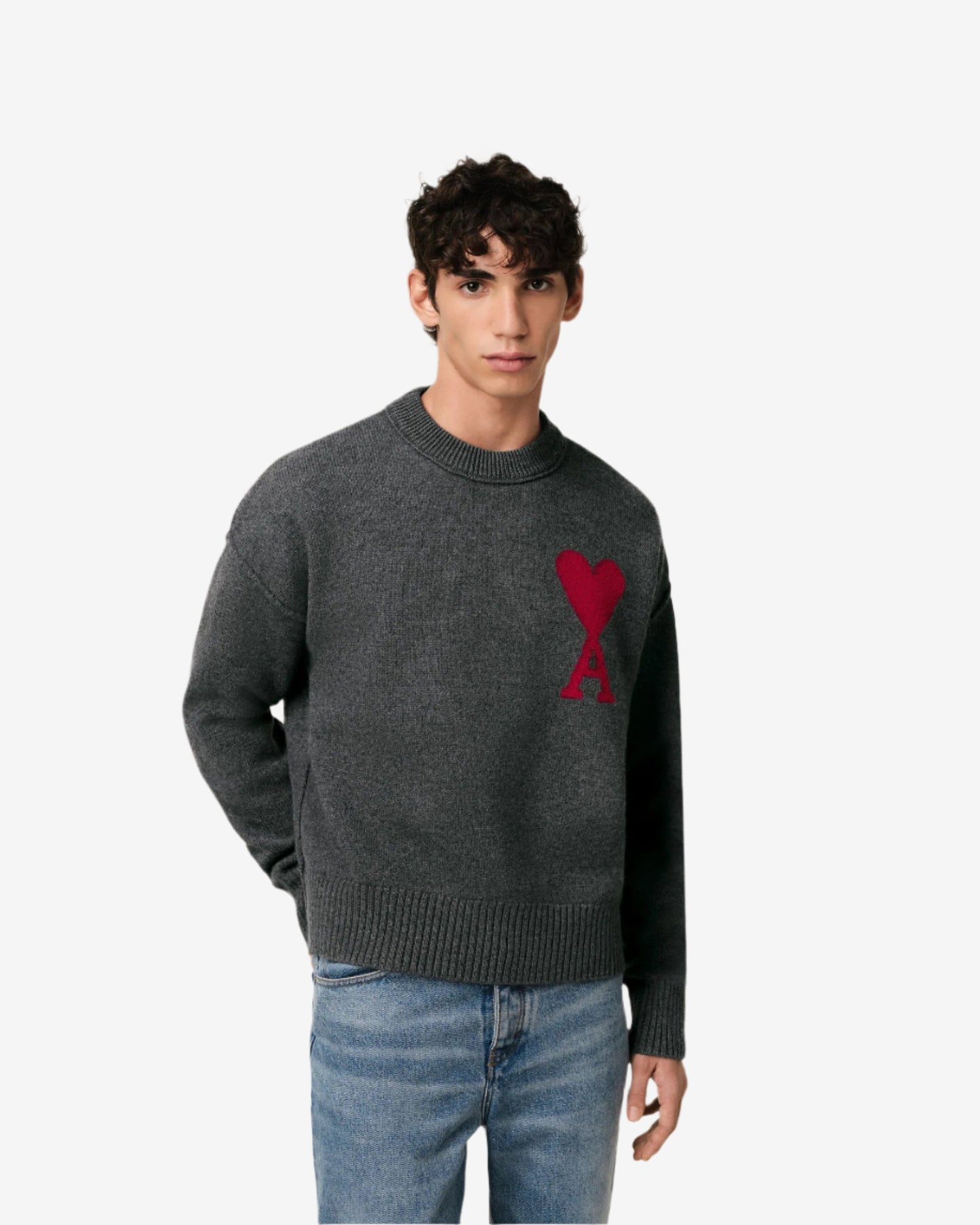 Gray sweater with a red heart design on a beige background