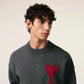 Gray sweater with a red heart design on a beige background