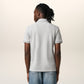 Gray polo shirt with a small red logo on a beige background