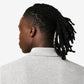 Gray polo shirt with a small red logo on a beige background
