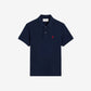 Navy blue polo shirt with a red heart logo on a beige background