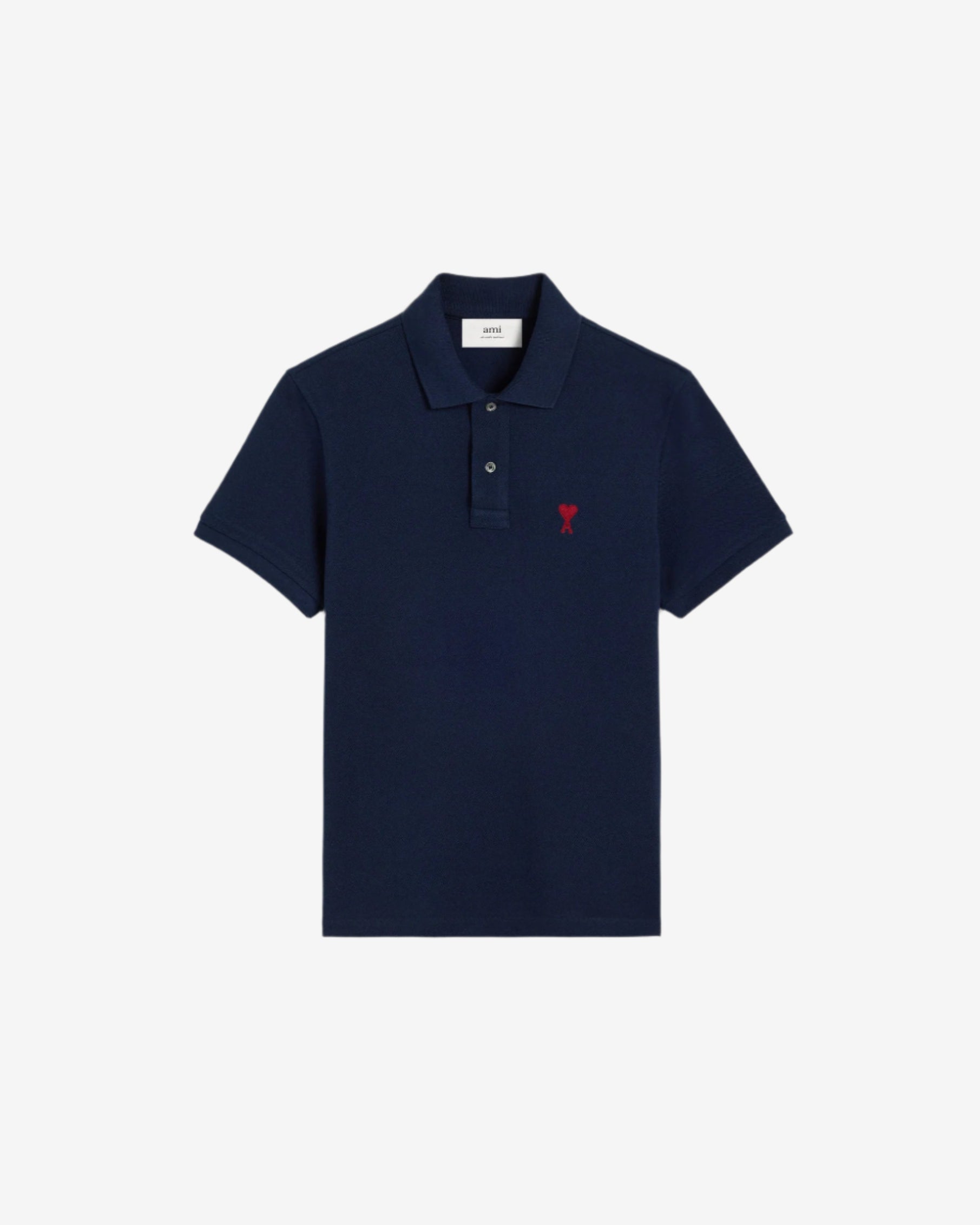 Navy blue polo shirt with a red heart logo on a beige background