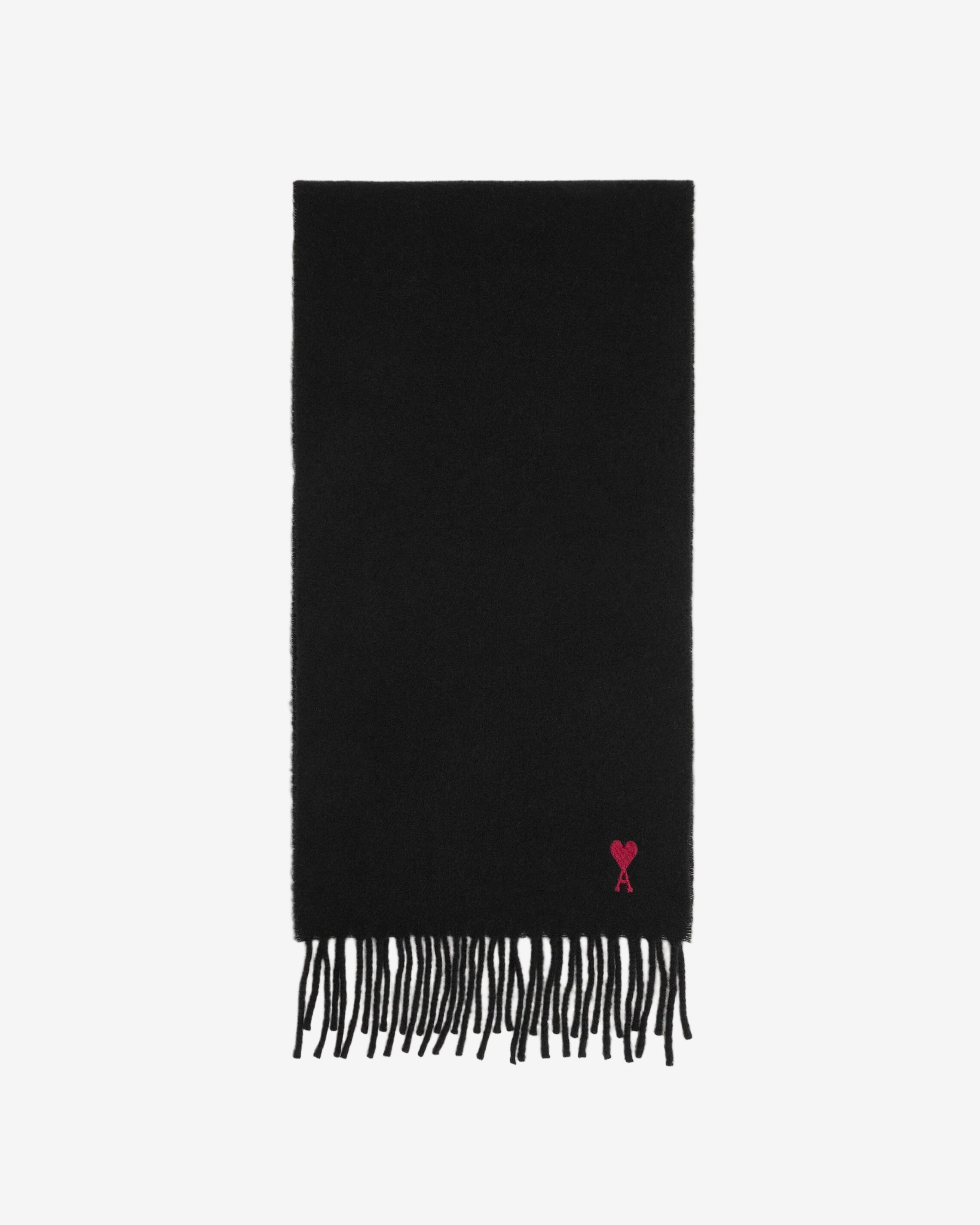 Black scarf with a small red heart emblem on a beige background