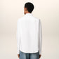 White polo shirt with a red logo on a beige background