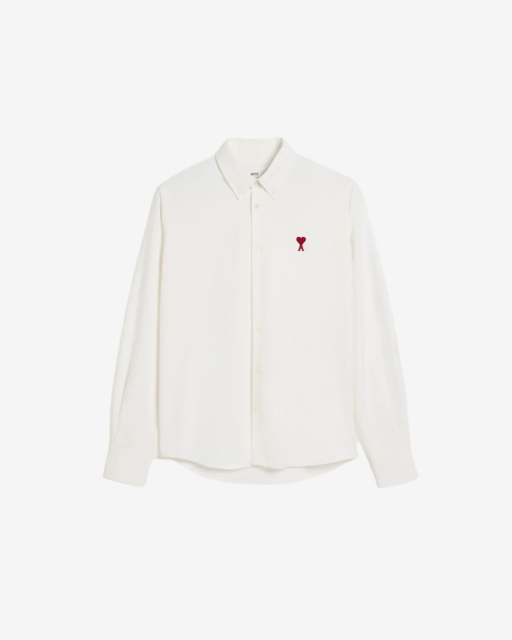 White polo shirt with a red logo on a beige background