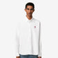 White polo shirt with a red logo on a beige background