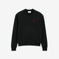 Black sweatshirt with a red logo on a beige background