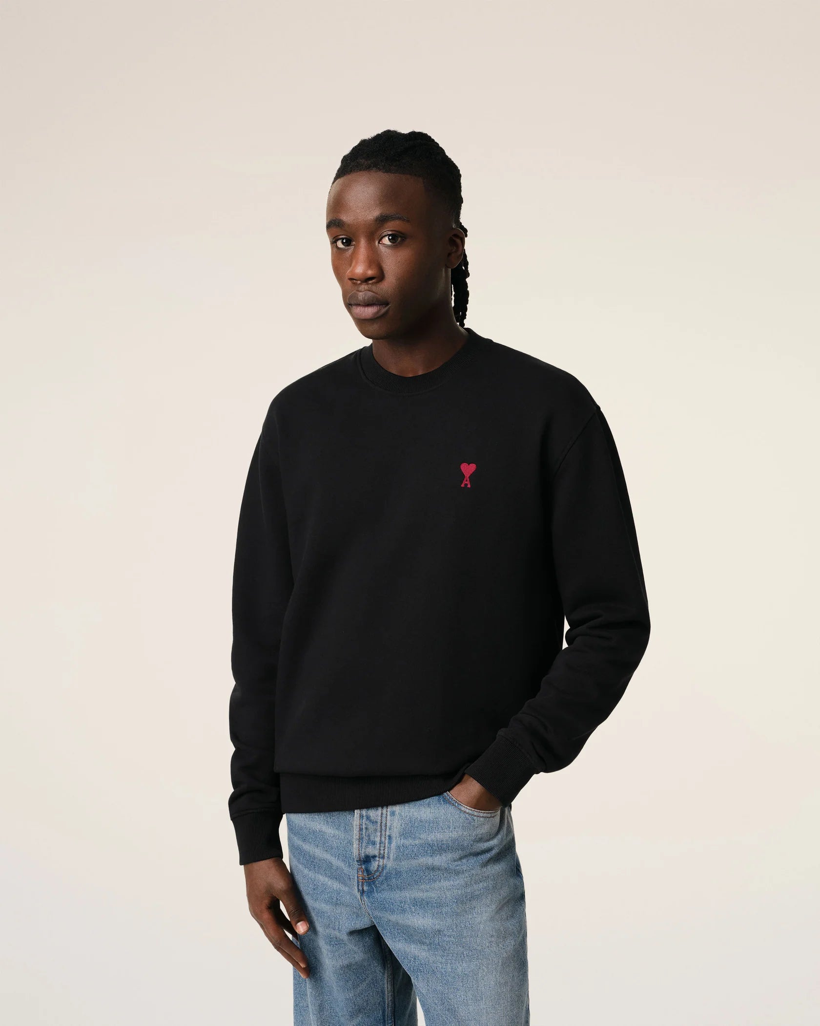 Black sweatshirt with a red logo on a beige background