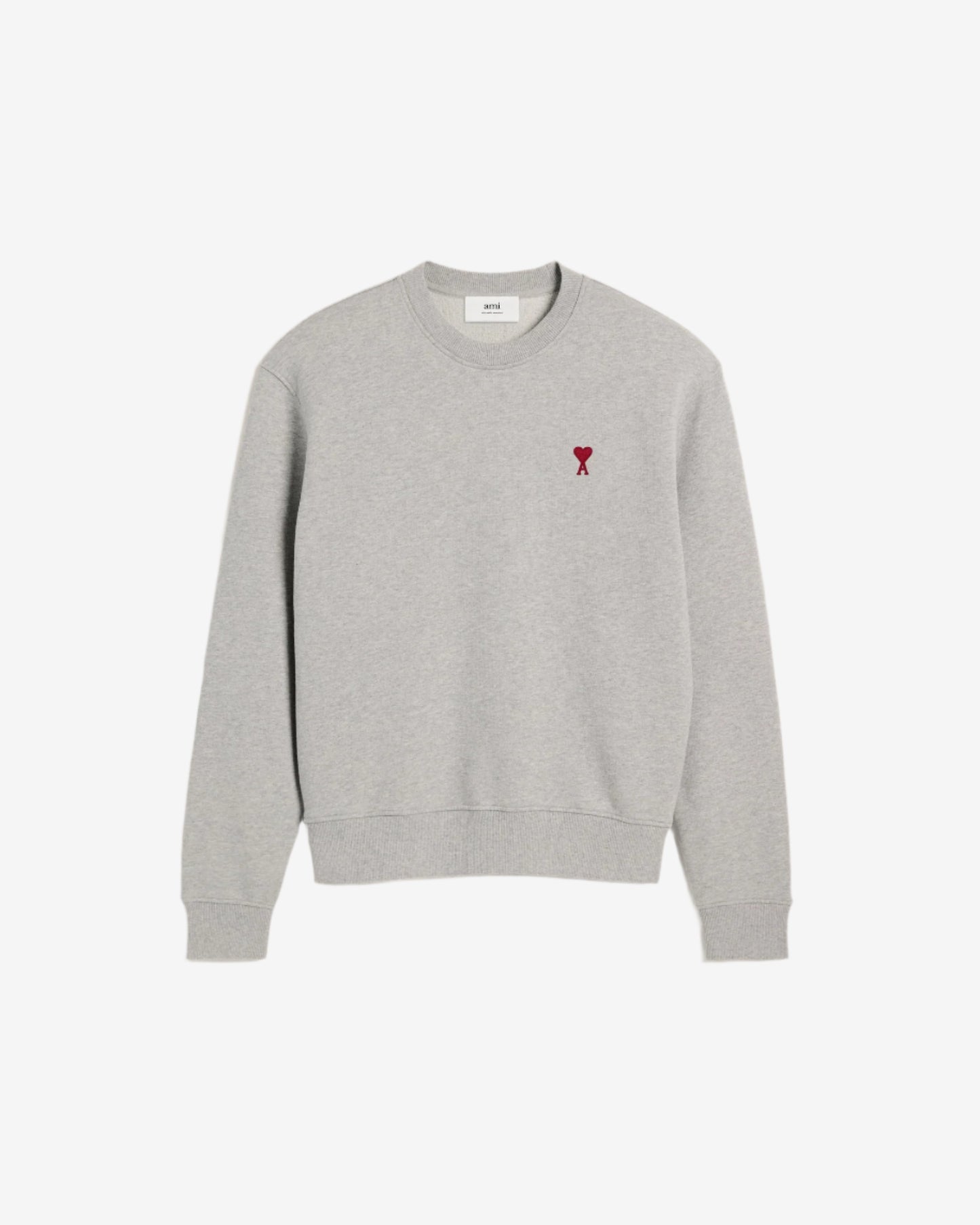 Gray sweatshirt with a small red heart design on a beige background