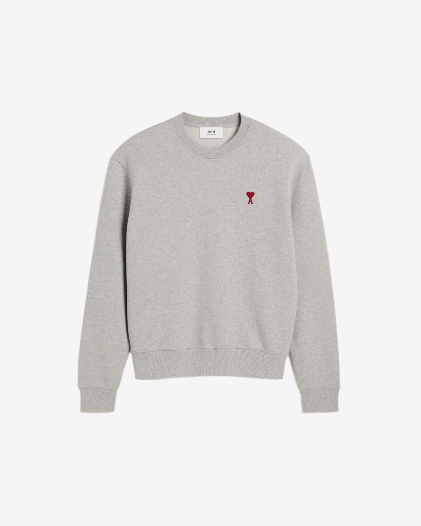 Gray sweatshirt with a small red heart design on a beige background