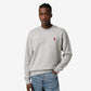Gray sweatshirt with a small red heart design on a beige background