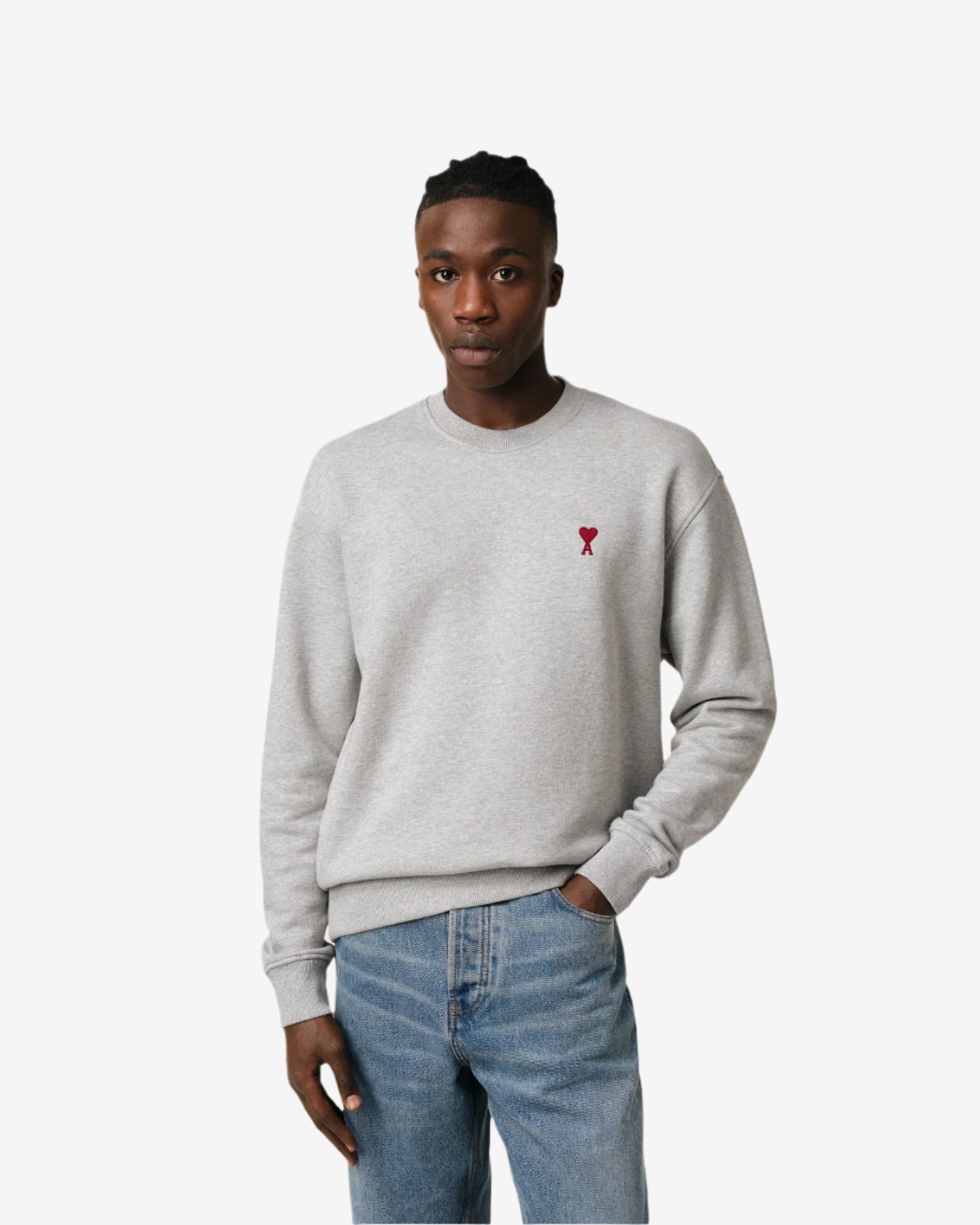 Gray sweatshirt with a small red heart design on a beige background