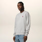 Gray sweatshirt with a small red heart design on a beige background
