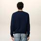 Navy blue sweatshirt with a red logo on a beige background ami paris