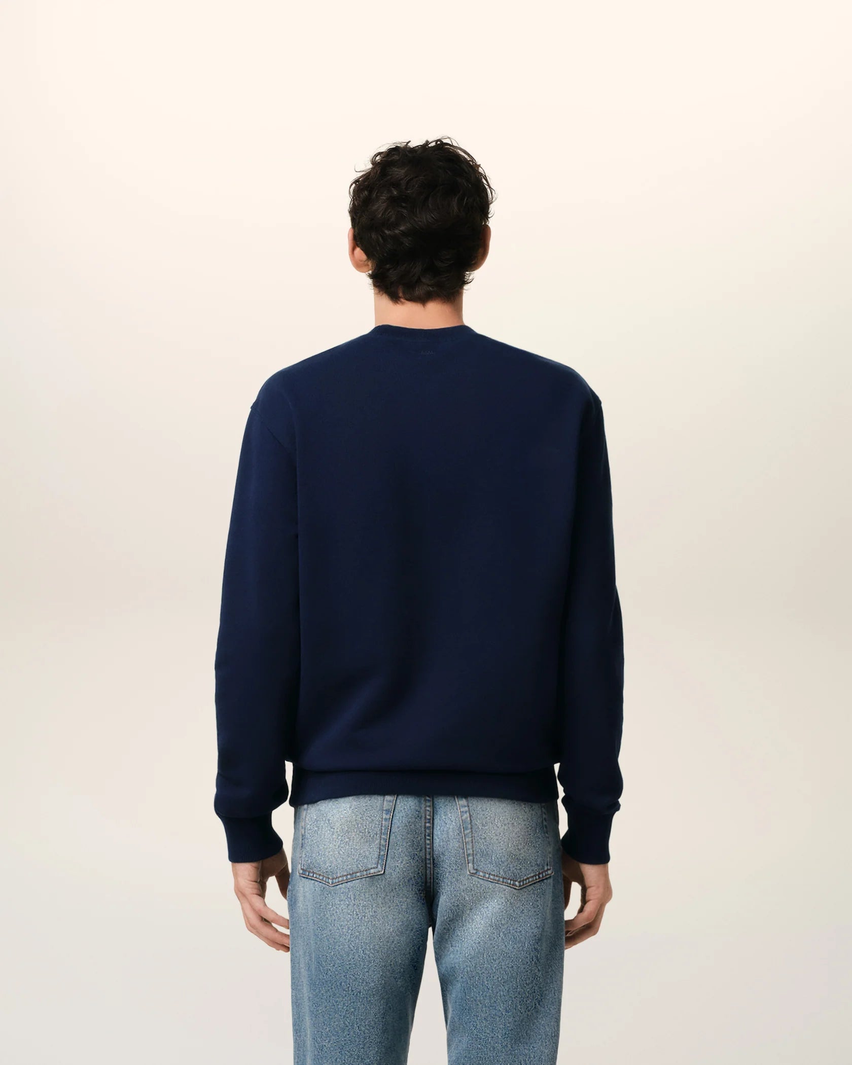 Navy blue sweatshirt with a red logo on a beige background ami paris