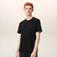 Black t-shirt with a small red logo on a beige background ami paris