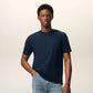Navy blue t-shirt with a small red logo on a beige background ami paris