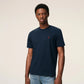 Navy blue t-shirt with a small red logo on a beige background ami paris
