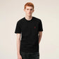 Black t-shirt with a small red logo on a beige background ami paris