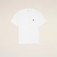 White t-shirt with a small red logo on a beige background Ami paris
