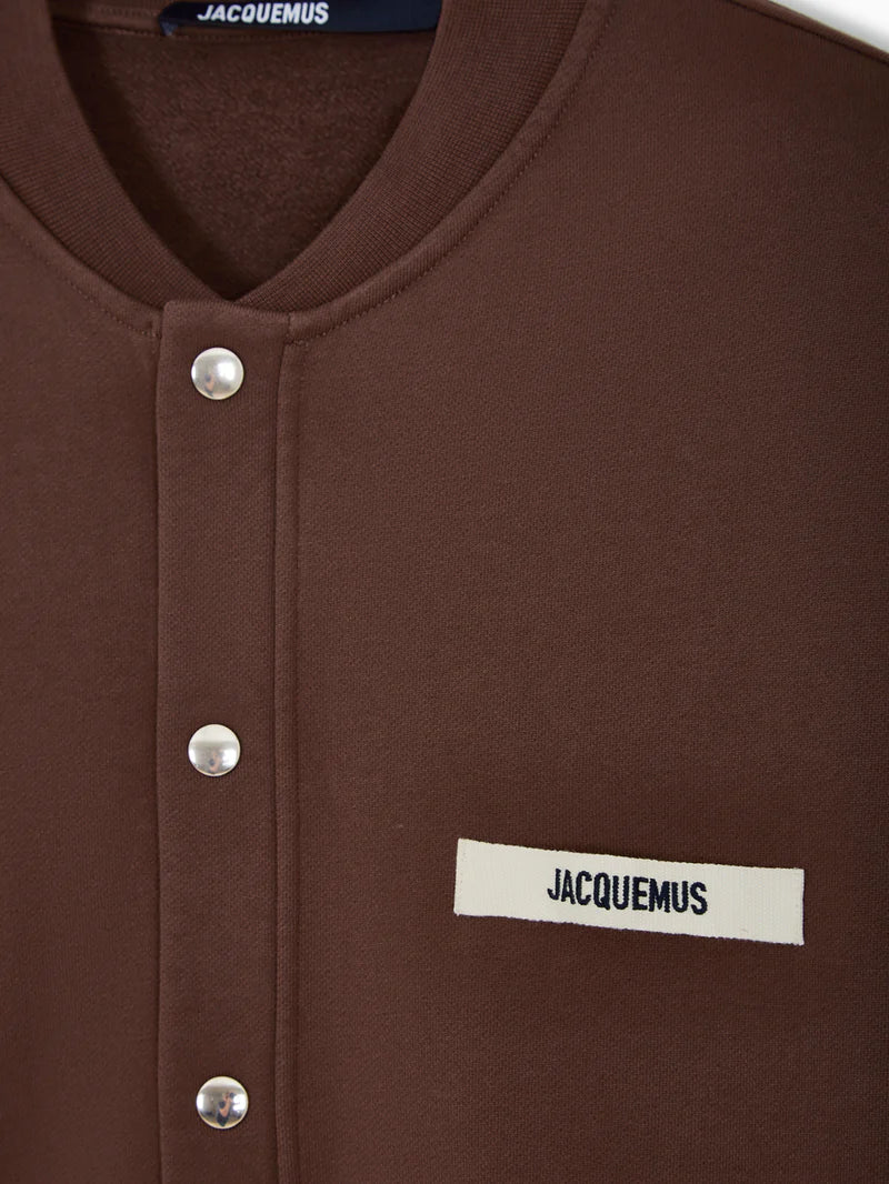 Brown jacket with a visible brand label on a white background