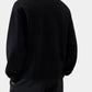 Black varsity jacket with a logo on the chest against a white background