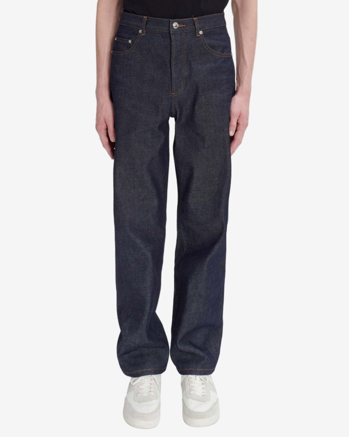 Dark blue jeans worn by a person on a white background