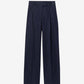 Navy blue pleated pants on a white background