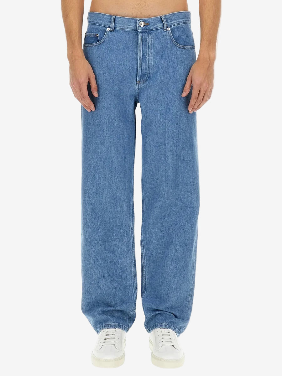 Blue jeans worn by a person on a white background