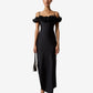 Woman wearing a black dress with floral details on a white background