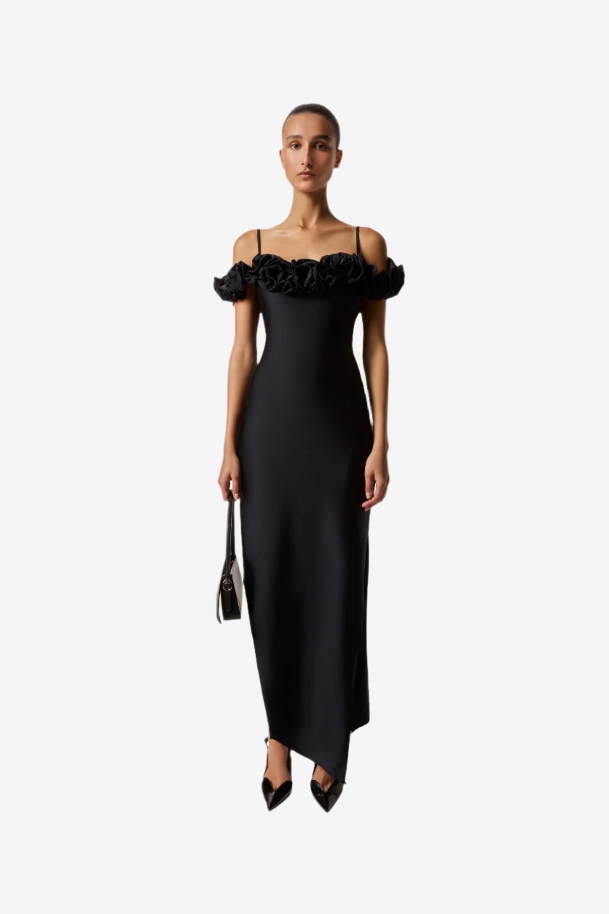 Woman wearing a black dress with floral details on a white background